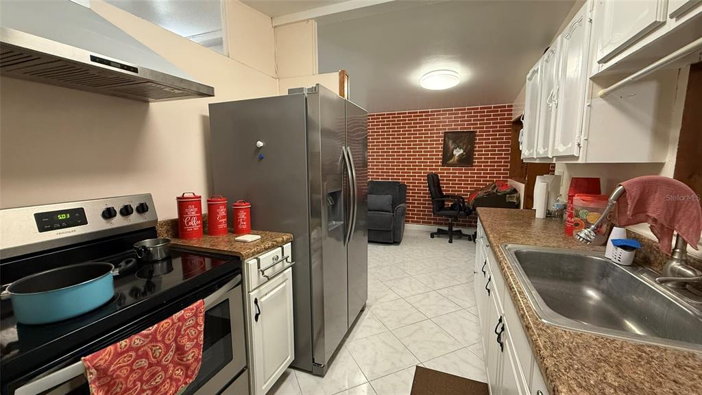 5754 9th Street Zephyrhills, FL 33542 - Photo 4 of 25 a kitchen with a stove and a sink