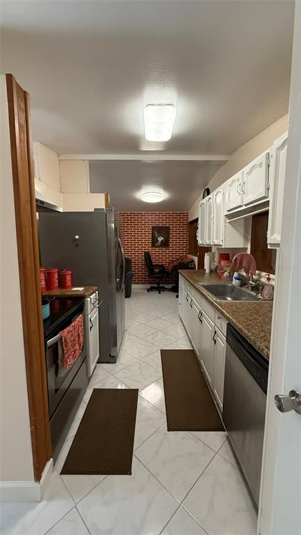 5754 9th Street Zephyrhills, FL 33542 - Photo 5 of 25 a kitchen with stainless steel appliances granite countertop a refrigerator and a stove