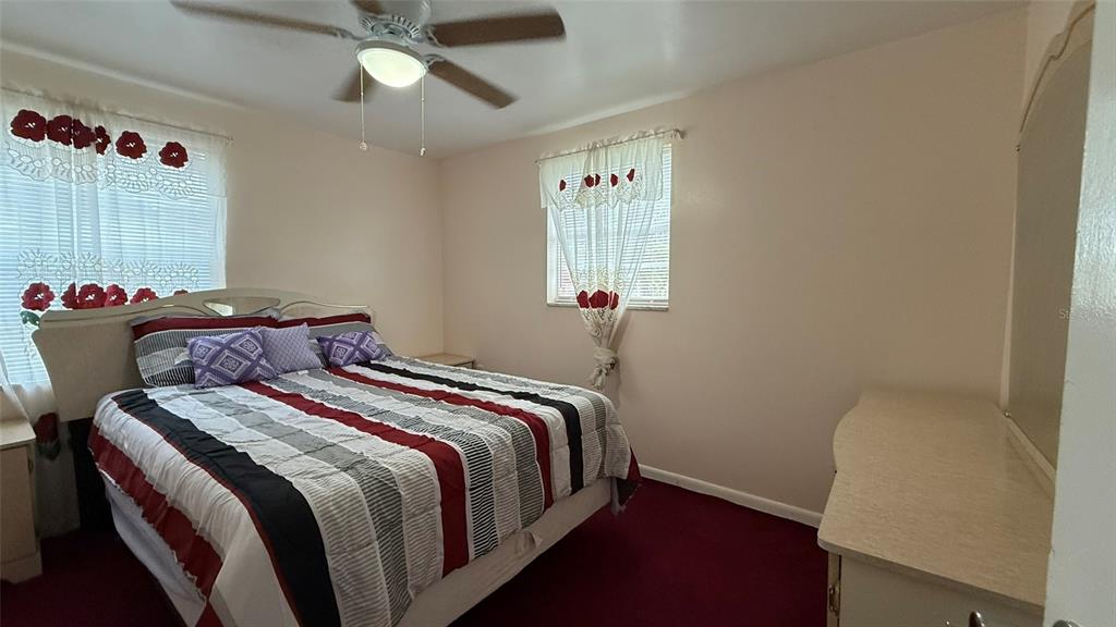 5754 9th Street Zephyrhills, FL 33542 - Photo 10 of 25 a bedroom with a bed and a window