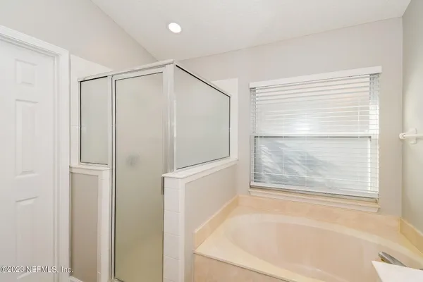 a bathroom with a bathtub and a shower
