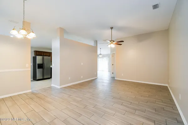 a view of a chandelier fan and wooden floor