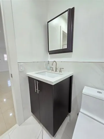 a bed sitting in a bedroom and flat screen tv