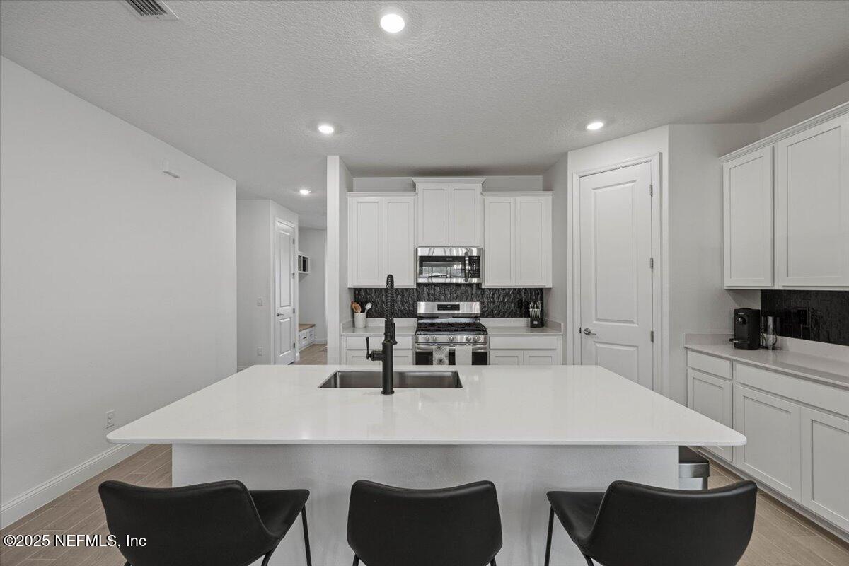 50 Dollar Court St. Augustine, FL 32092 - Photo 12 of 55 a kitchen with a dining table chairs and white appliances