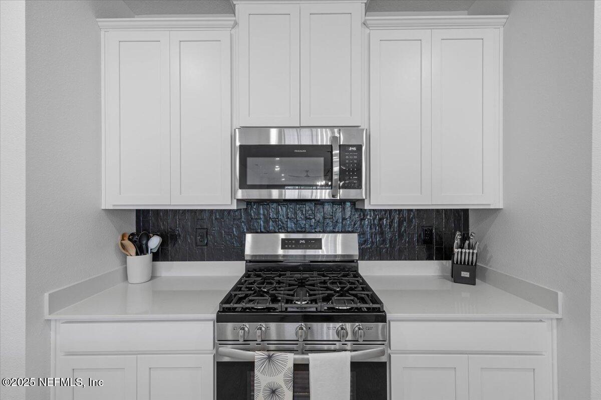 50 Dollar Court St. Augustine, FL 32092 - Photo 14 of 55 a kitchen with a stove and white cabinets