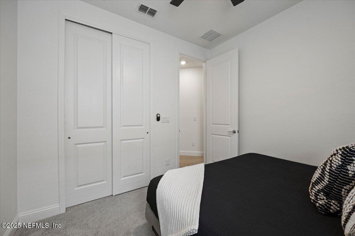 50 Dollar Court St. Augustine, FL 32092 - Photo 30 of 55 a bedroom with a bed and a shower