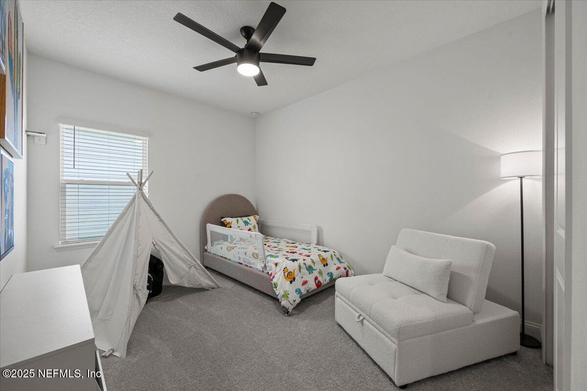 50 Dollar Court St. Augustine, FL 32092 - Photo 31 of 55 a living room with furniture and a chandelier