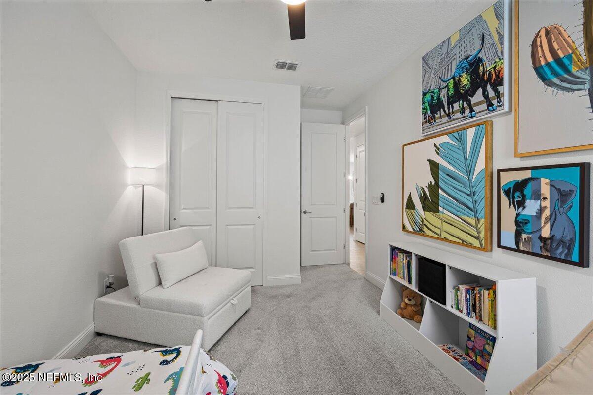 50 Dollar Court St. Augustine, FL 32092 - Photo 32 of 55 a living room with furniture and baby crib