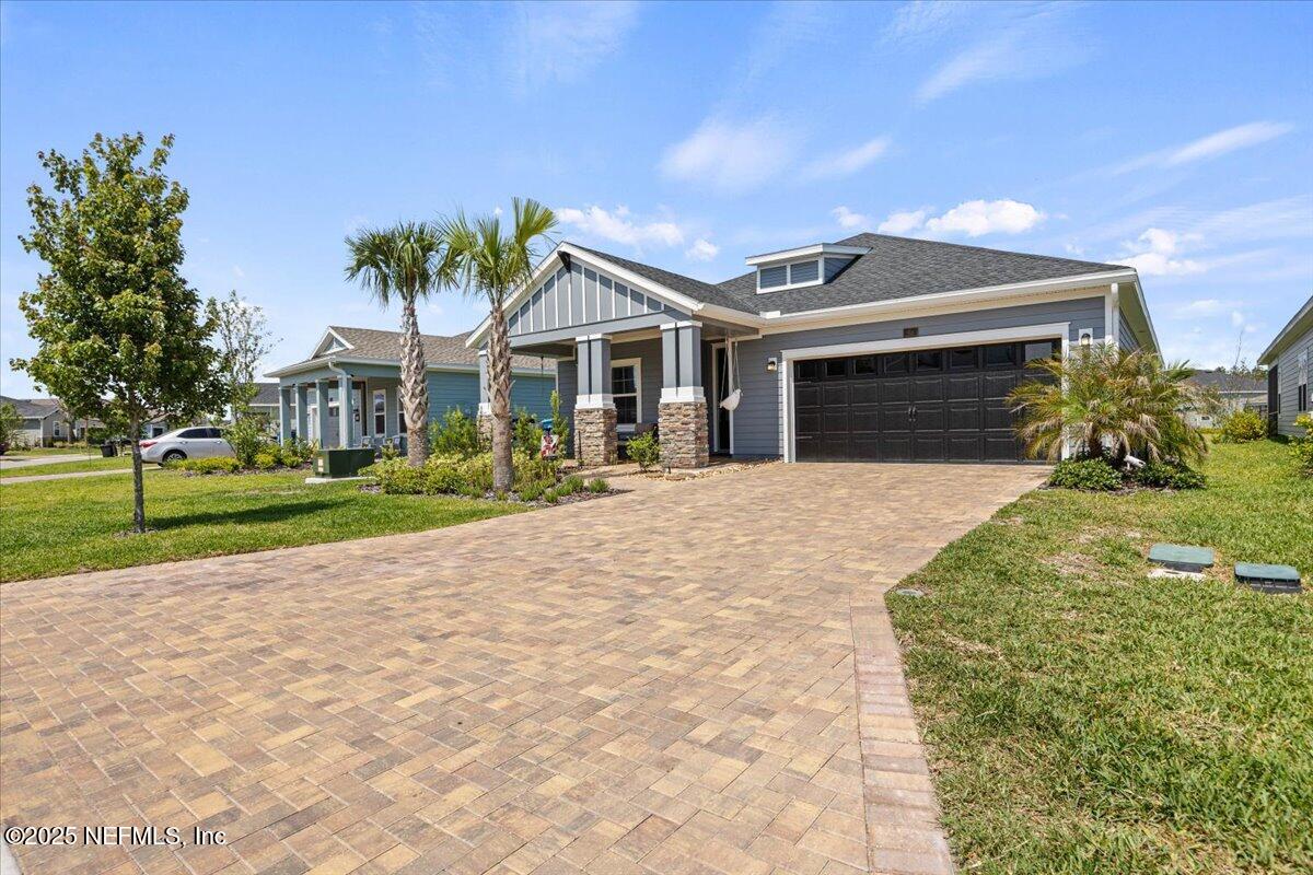 50 Dollar Court St. Augustine, FL 32092 - Photo 4 of 55 a front view of a house with a yard and potted plants
