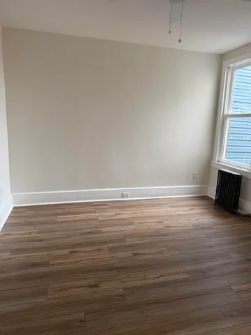 a view of room with wooden floor and window