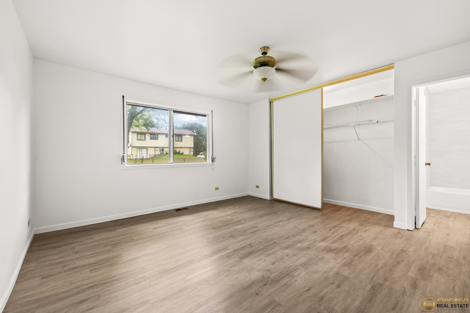 142 Cloverleaf Road Matteson, IL 60443 - Photo 11 of 22 a view of an empty room with a window and a ceiling fan