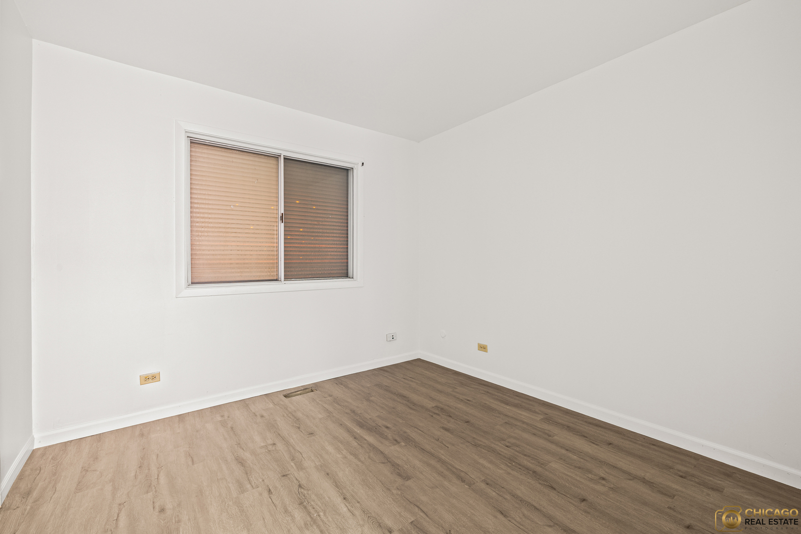 142 Cloverleaf Road Matteson, IL 60443 - Photo 19 of 22 an empty room with wooden floor and windows