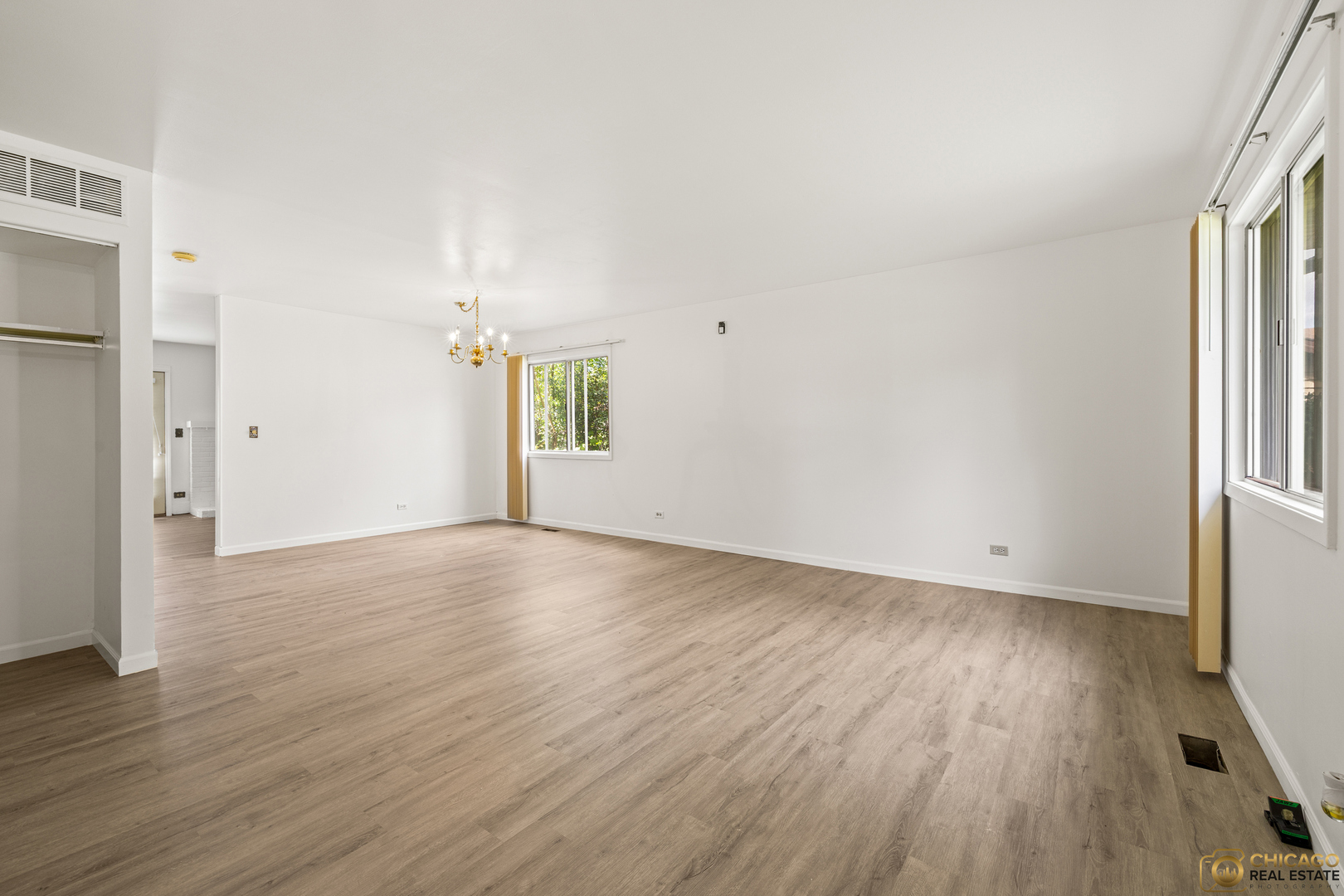 142 Cloverleaf Road Matteson, IL 60443 - Photo 3 of 22 an empty room with wooden floor and windows