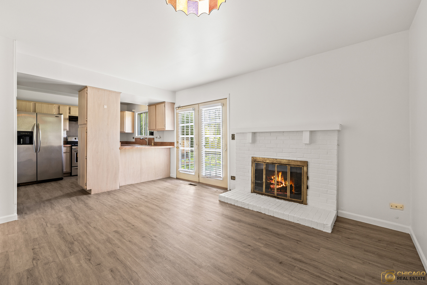 142 Cloverleaf Road Matteson, IL 60443 - Photo 5 of 22 a view of a room with wooden floor and a fireplace