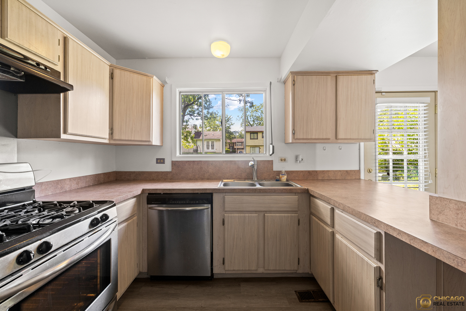 142 Cloverleaf Road Matteson, IL 60443 - Photo 8 of 22 a kitchen with a sink stove top oven and cabinets