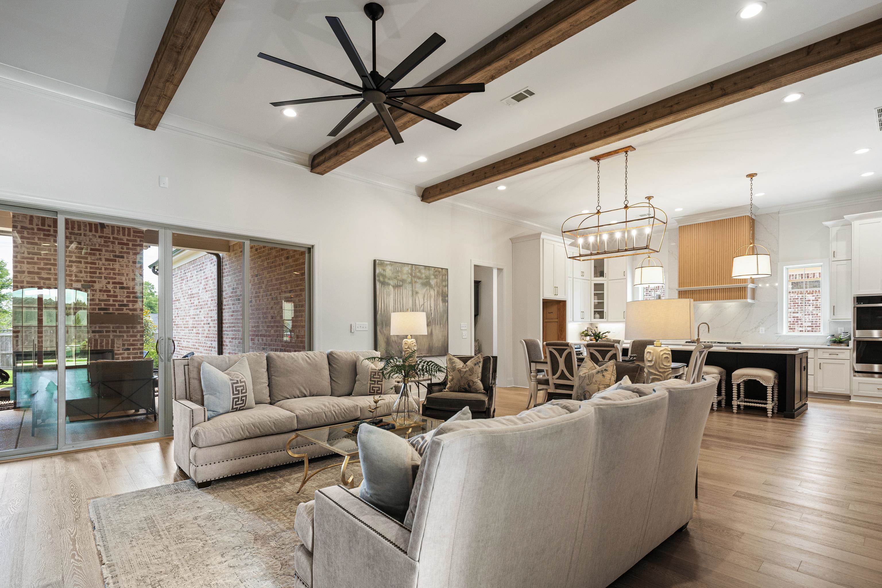 284 Keisie Lane Collierville, TN 38017 - Photo 8 of 34 Open-concept living space featuring wood-finish flooring, exposed ceiling beams, recessed lighting, and a contemporary ceiling fan