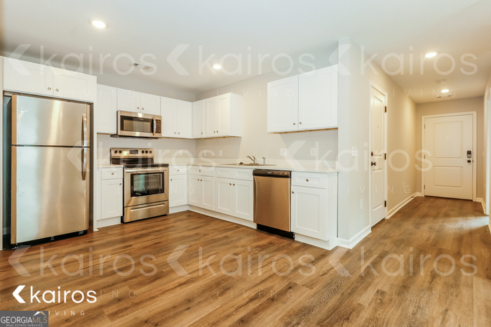 126 Cottage Grove Road Brunswick, GA 31525 - Photo 8 of 17 a kitchen with granite countertop a refrigerator and a stove