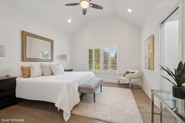 a bedroom with a large bed and a chandelier