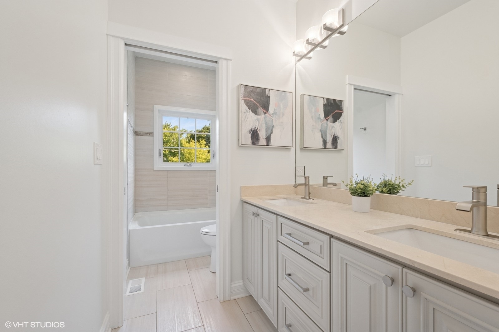1635 Elder Lane Northfield, IL 60093 - Photo 18 of 30 a bathroom with a granite countertop sink two mirror and a bathtub