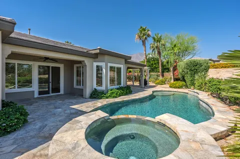 a view of a house with swimming pool and porch