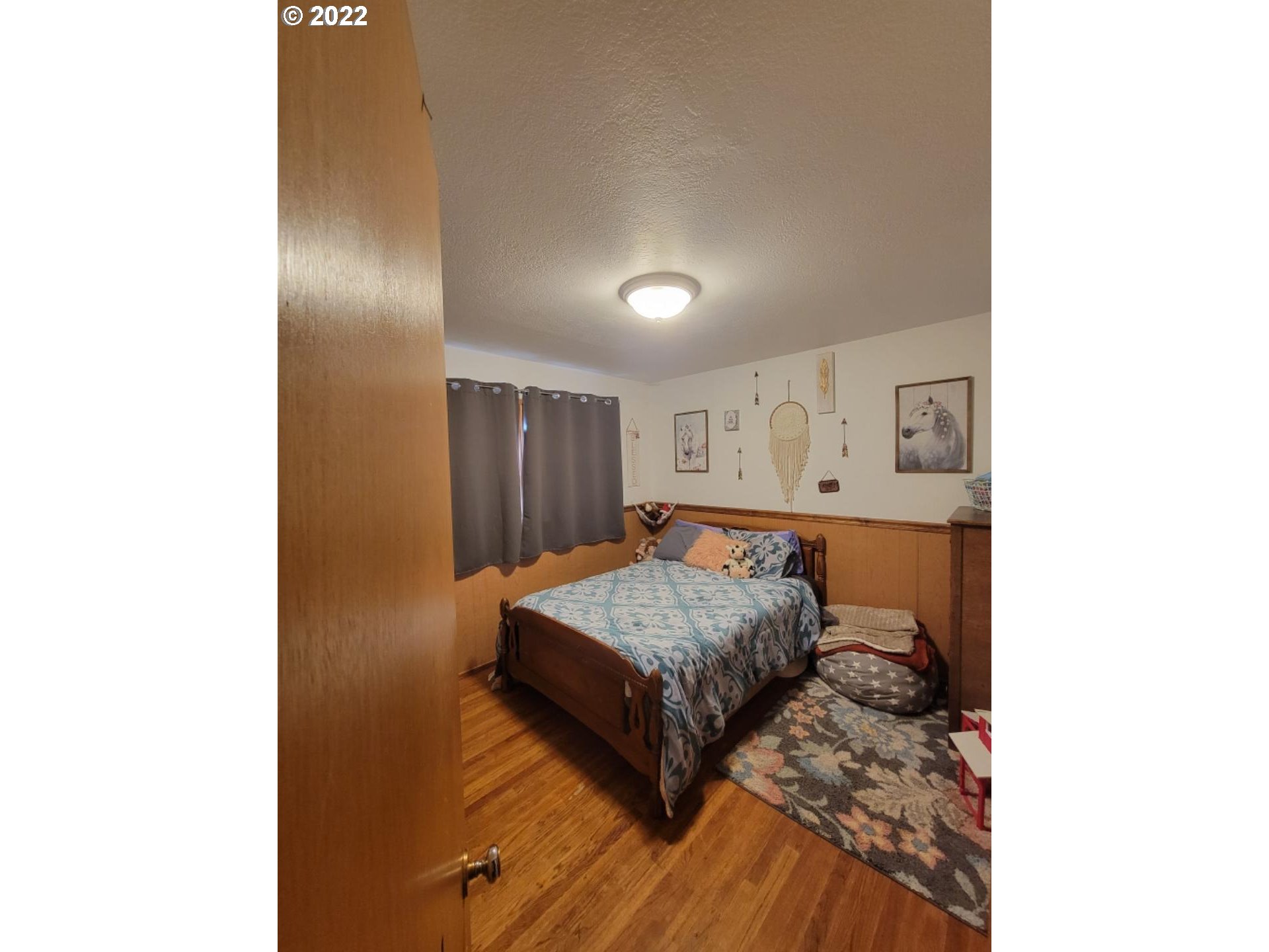 3124 Southwest Hailey Avenue Pendleton, OR 97801 - Photo 8 of 15 a living room with a bed and a dresser