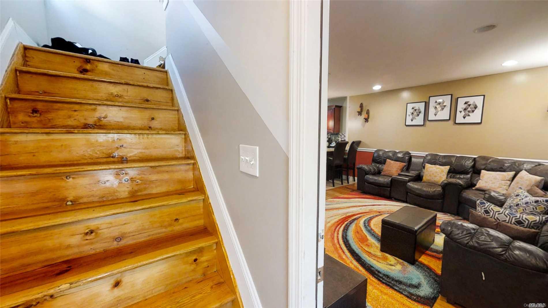 176-32 133rd Road Queens, NY 11434 - Photo 5 of 11 a bed room with a bed and a black couch