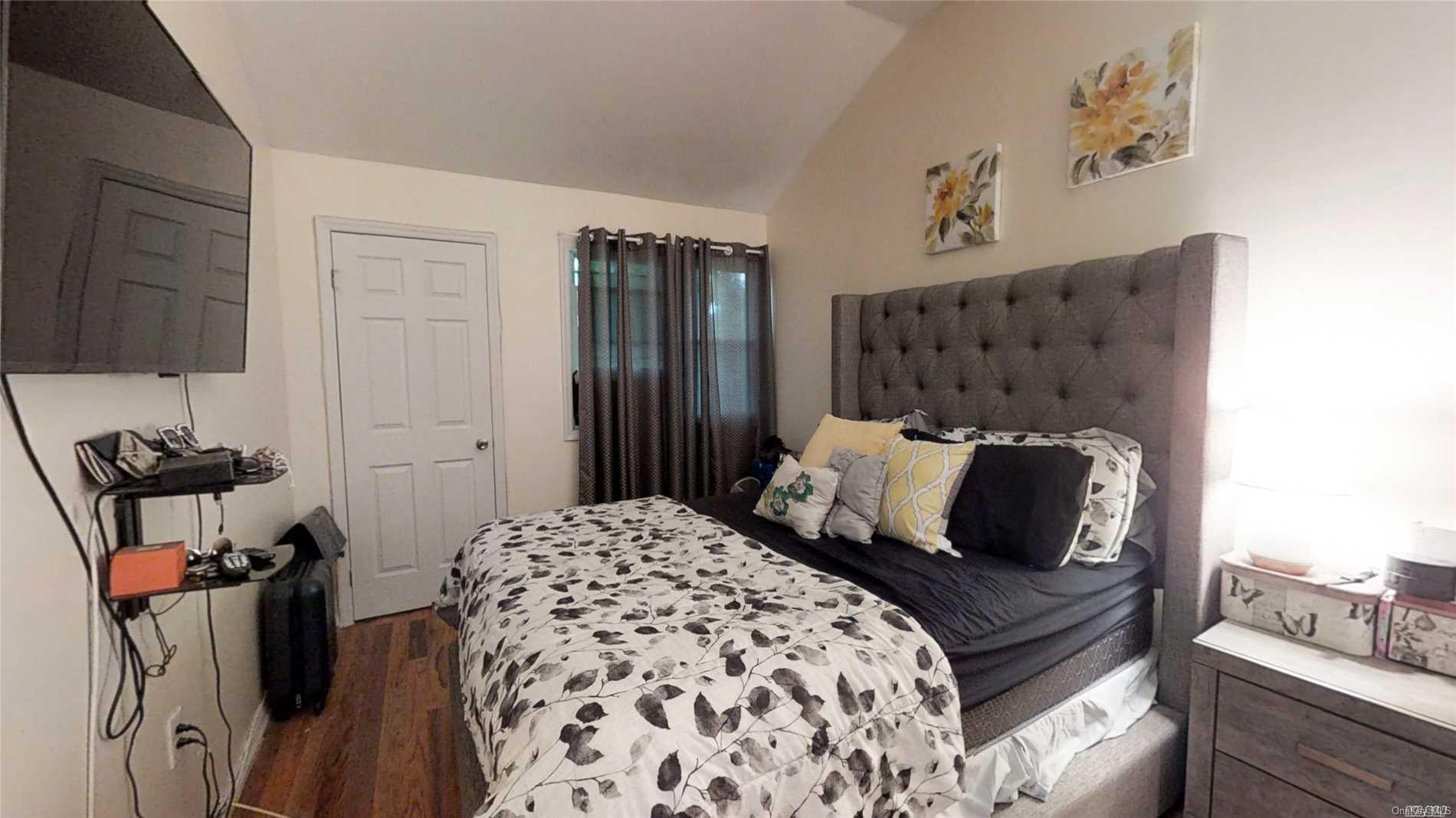 176-32 133rd Road Queens, NY 11434 - Photo 6 of 11 a bedroom with a bed and wooden floor