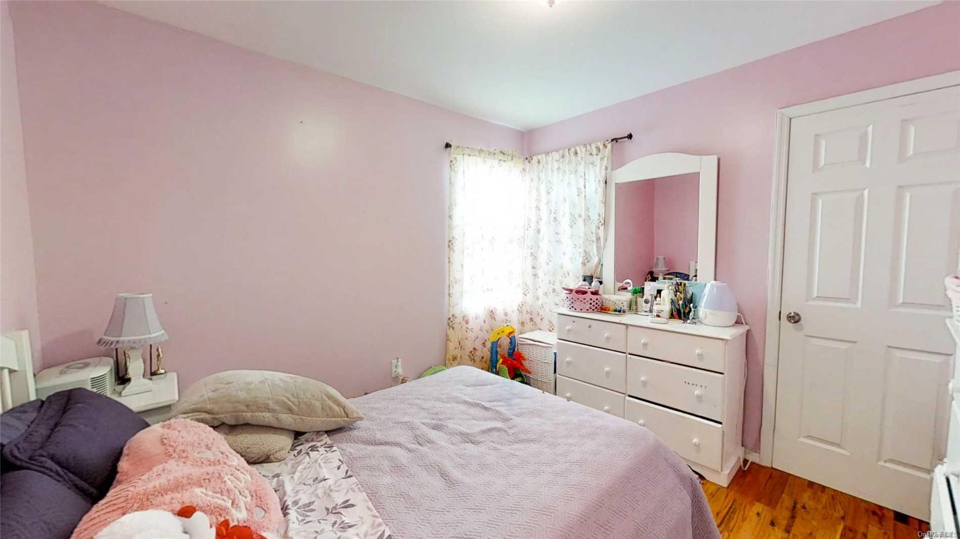 176-32 133rd Road Queens, NY 11434 - Photo 7 of 11 a bedroom with a bed and a window