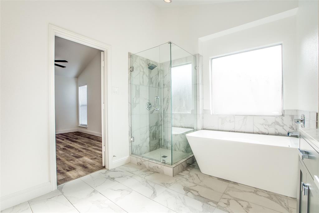8341 Edgewater Drive Frisco, TX 75034 - Photo 11 of 22 a bathroom with a bathtub and a shower