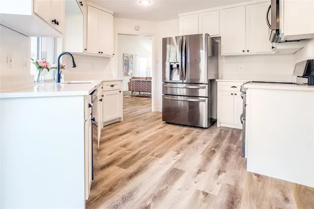 a kitchen with a refrigerator sink and stainless steel appliances