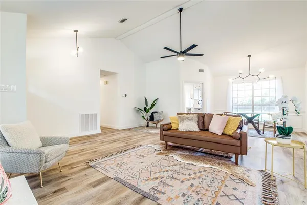 a living room with furniture ceiling fan and a rug