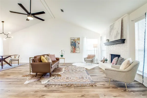 a living room with furniture a rug and a fireplace