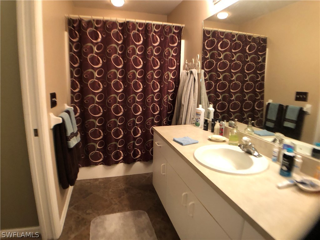 17441 Braddock Road Fort Myers, FL 33967 - Photo 11 of 29 a bathroom with a sink and a mirror