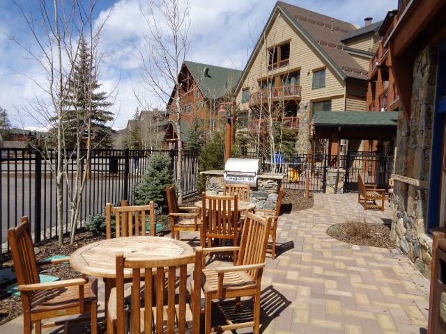 129 River Run Road, Unit 8036 Keystone, CO 80435 - Photo 17 of 20 a view of a patio with a dining table and chairs with wooden floor