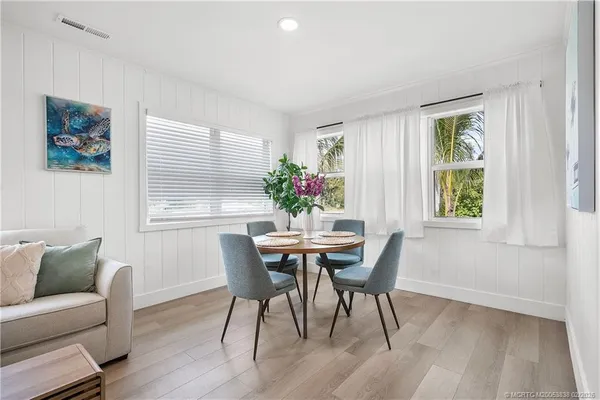 a view of a dining room with furniture and wooden floor