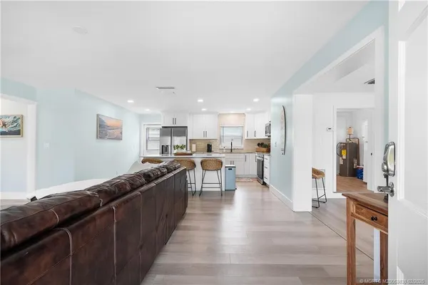 a large kitchen with a lot of counter space and stainless steel appliances