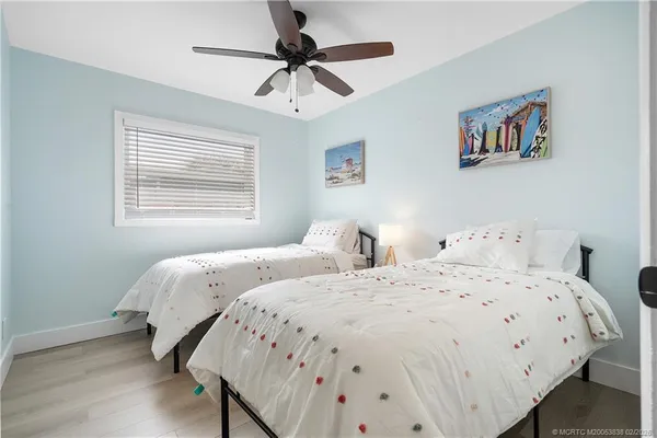 a bedroom with a bed and a ceiling fan