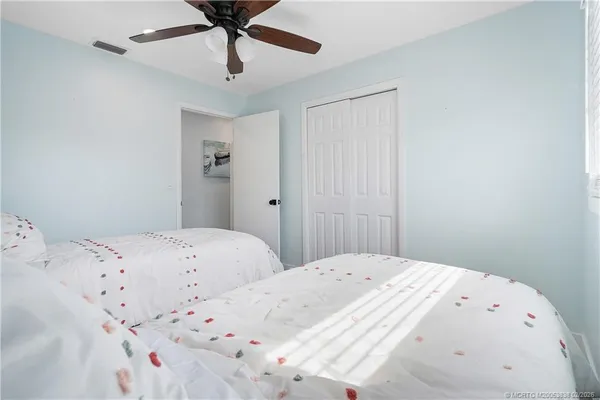 a bedroom with a large bed and a chandelier