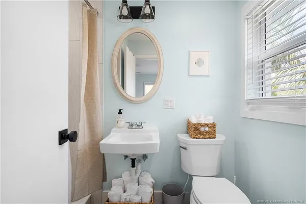 a bathroom with a toilet sink and mirror