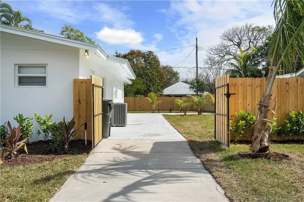 a backyard of a house with plants and trees