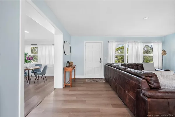 a living room with furniture and a dining table