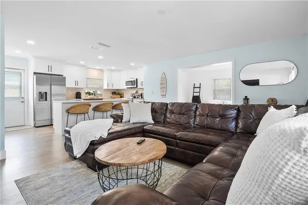 a living room with furniture and a dining table