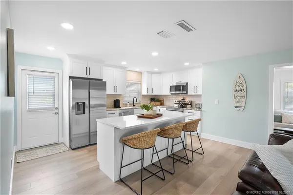 a kitchen with refrigerator and window