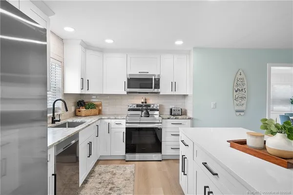 a kitchen with a sink stove and cabinets