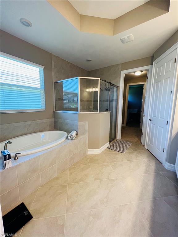 14715 Kelson Circle Naples, FL 34114 - Photo 13 of 35 a view of an empty room with wooden floor and a window