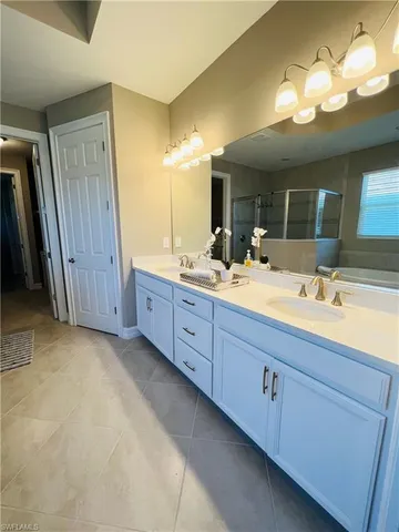 a bathroom with a double vanity sink and a mirror