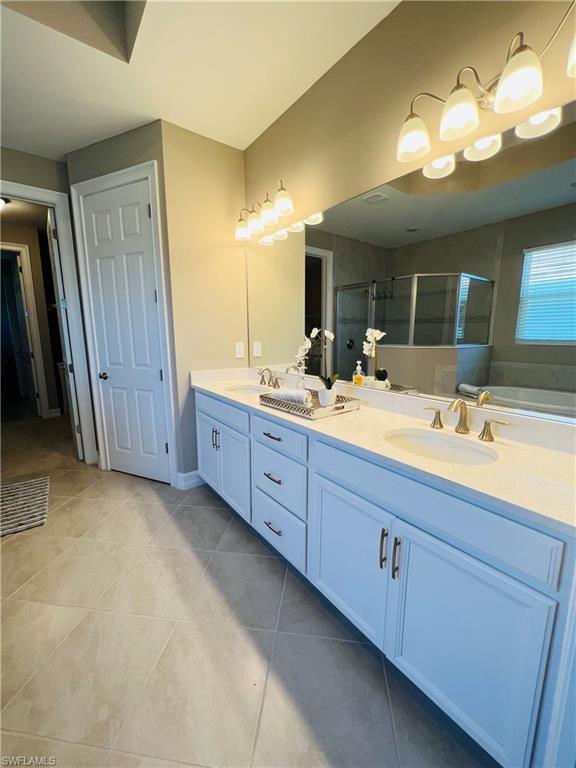 14715 Kelson Circle Naples, FL 34114 - Photo 14 of 35 a bathroom with a double vanity sink and a mirror