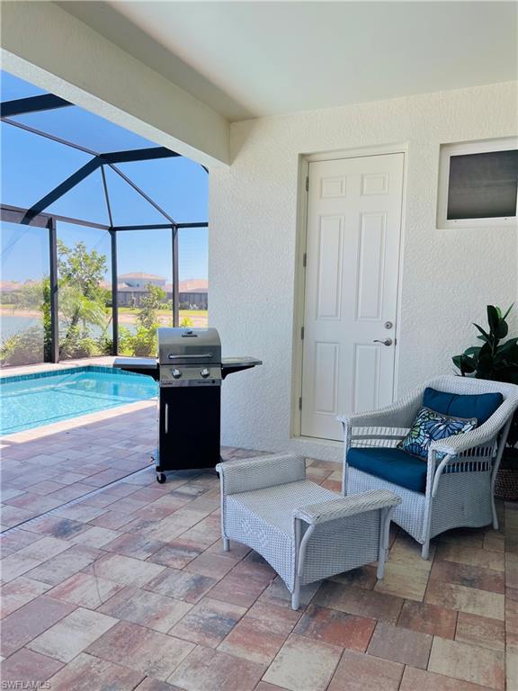 14715 Kelson Circle Naples, FL 34114 - Photo 20 of 35 a living room with furniture and a floor to ceiling window