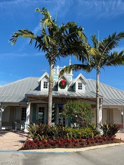 14715 Kelson Circle Naples, FL 34114 - Photo 21 of 35 a front view of a house with a garden