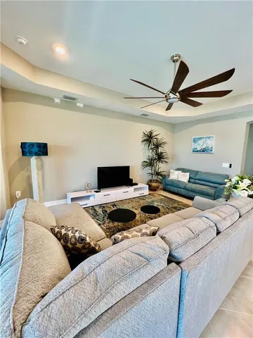 a bedroom with a bed and a ceiling fan