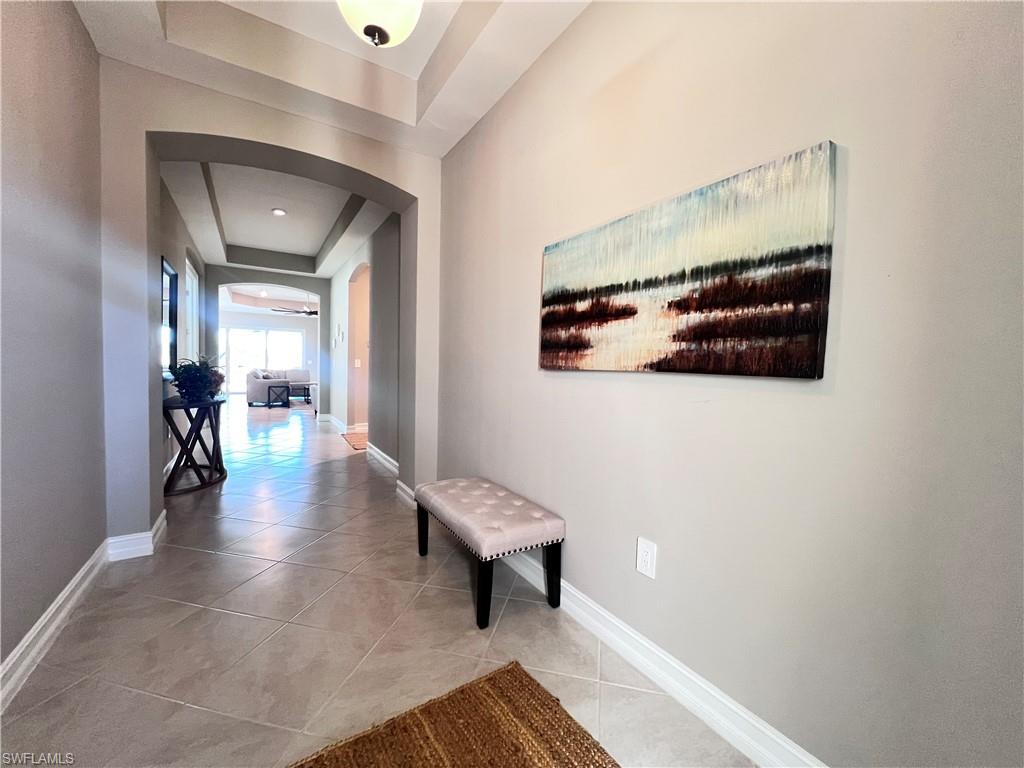 14715 Kelson Circle Naples, FL 34114 - Photo 7 of 34 a view of a hallway with couch and a potted plant